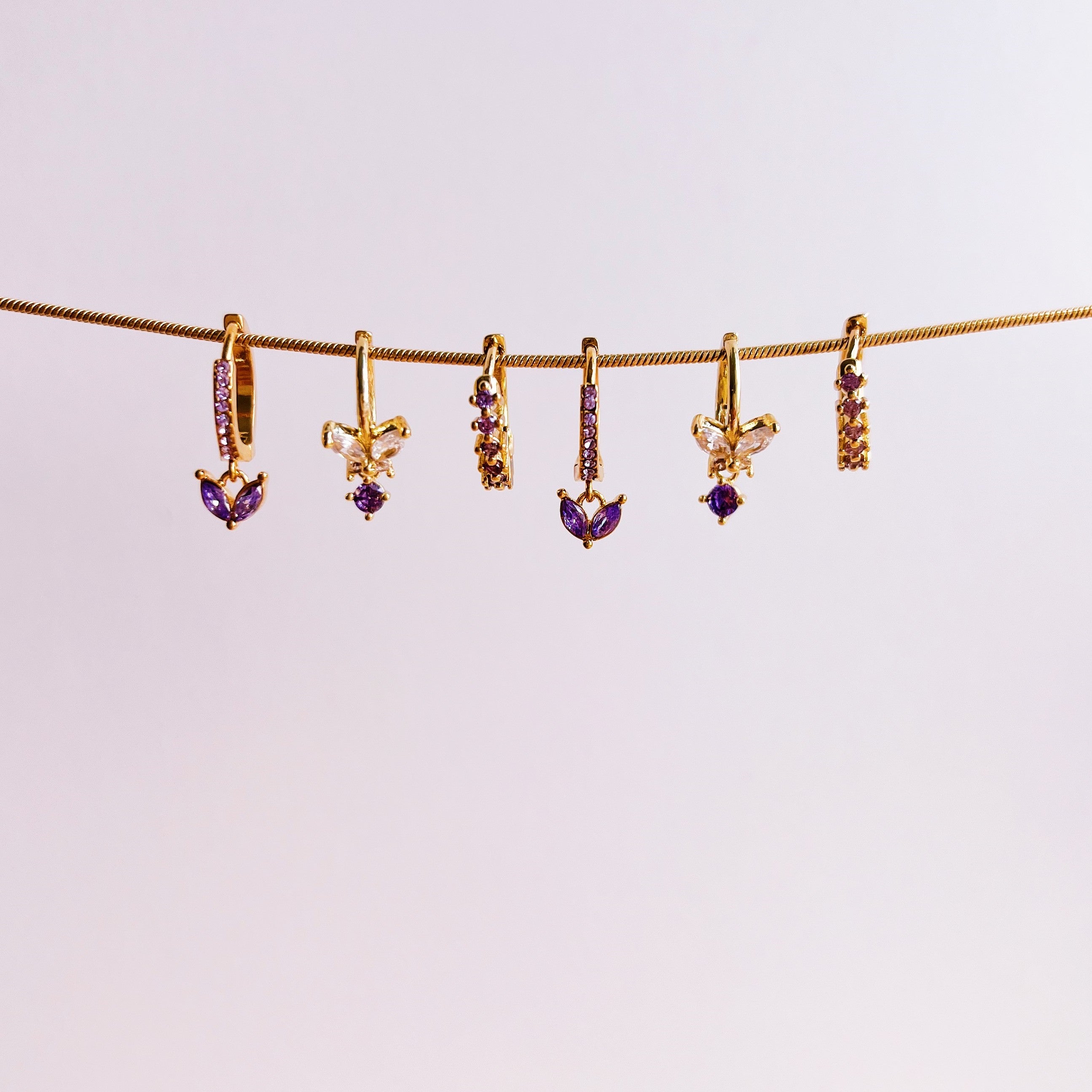 Sparkling diamond hoops purple