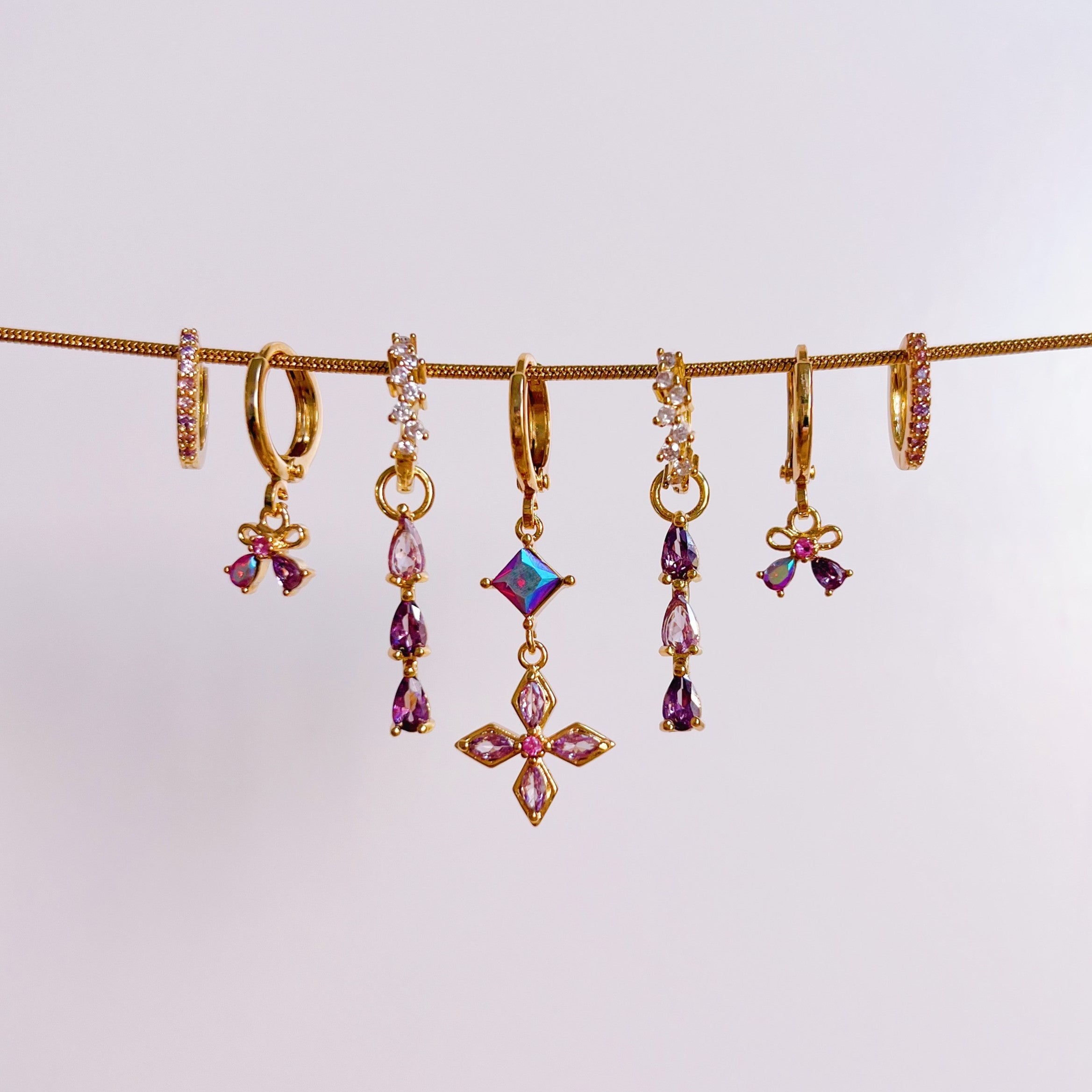 Earrings shining bow purple